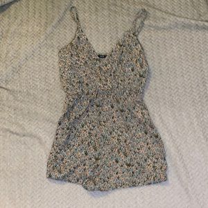 Floral romper in the shade of green. Mint condition never been worn